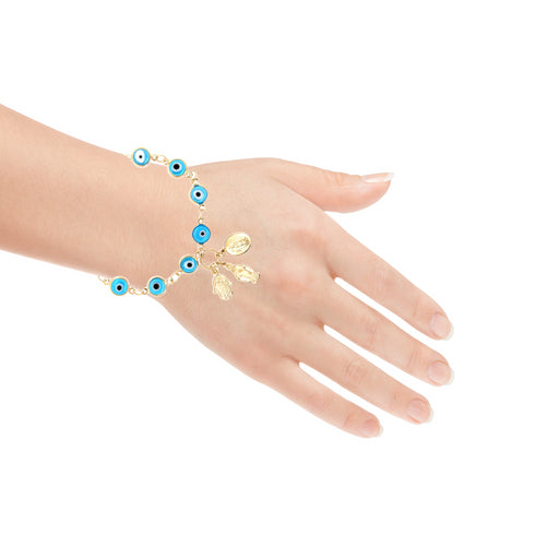 The Aqua Blue Evil Eye Charm Bracelet, featuring gold accents such as a Hamsa hand and Virgin Mary pendant, is elegantly displayed on a white background.